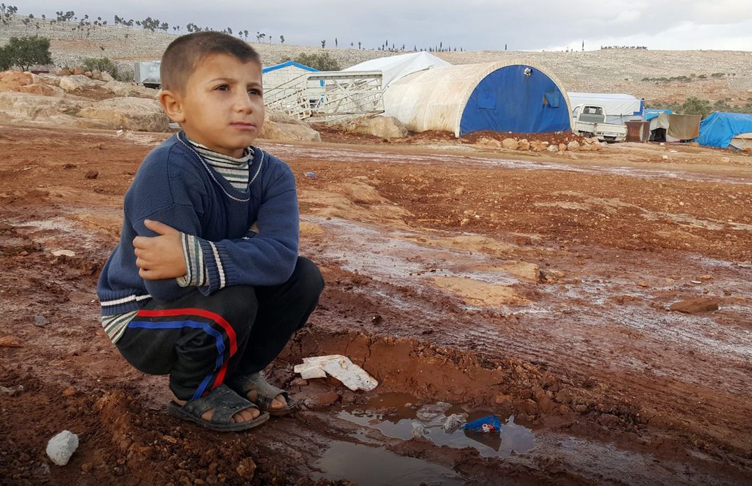 Childhood innocence has been lost A young boy in a Syrian displacement camp.